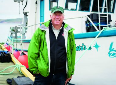 David Miller stands on the dock near a fishing boat